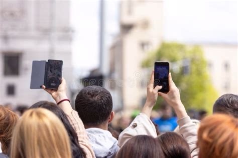 Crowd at a protest recording on smartphones, representing echo chambers and media performance over truth