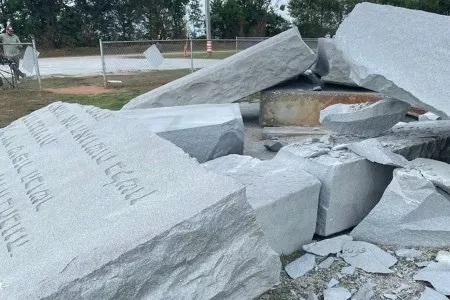 Collapsed remains of the Georgia Guidestones monument after the July 2022 bombing in Elbert County, Georgia, showing broken granite slabs and debris scattered across the site—capturing the aftermath of the controversial destruction.