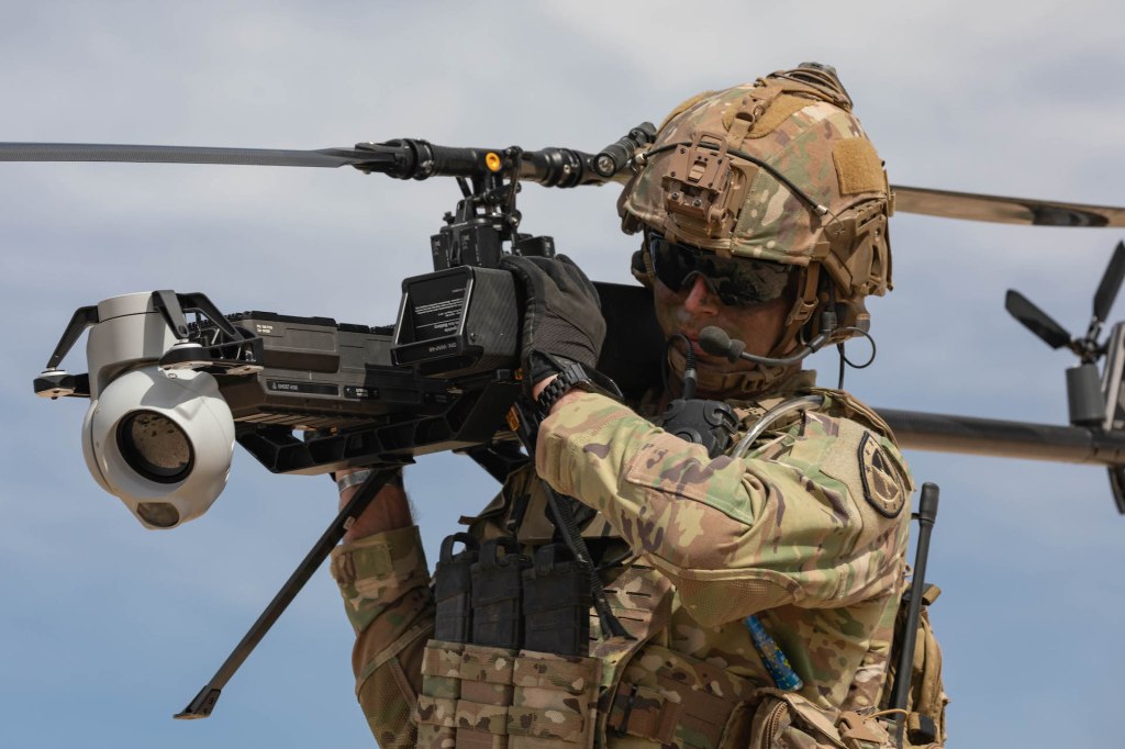 U.S. soldier prepares an Anduril Ghost-X drone for deployment in live field conditions.
