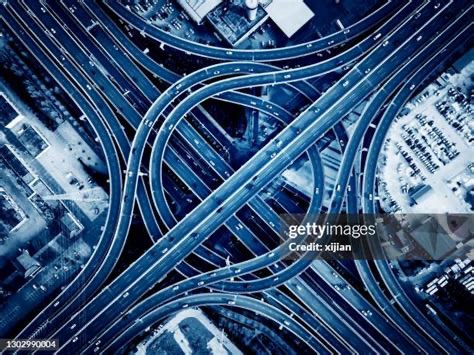 Overhead view of Atlanta’s massive highway interchange, a tangle of overlapping lanes resembling mythic concentric circles etched into the earth.
