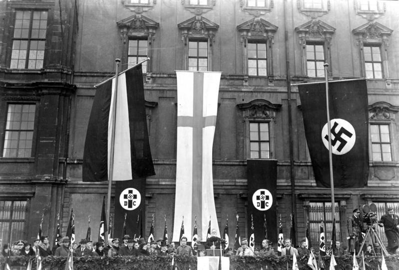 German Christians rally in Berlin, 1933, with DC (“Deutsche Christen”) and swastika banners on the Berlin City Palace.